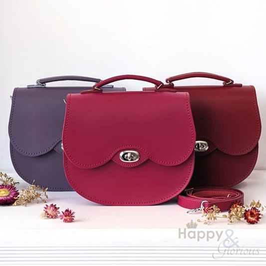 Magenta twist lock leather saddle bag