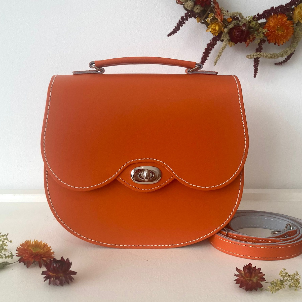 Orange handmade leather twist lock saddle bag