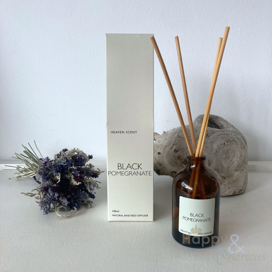 Black pomegranate reed diffuser in amber glass bottle