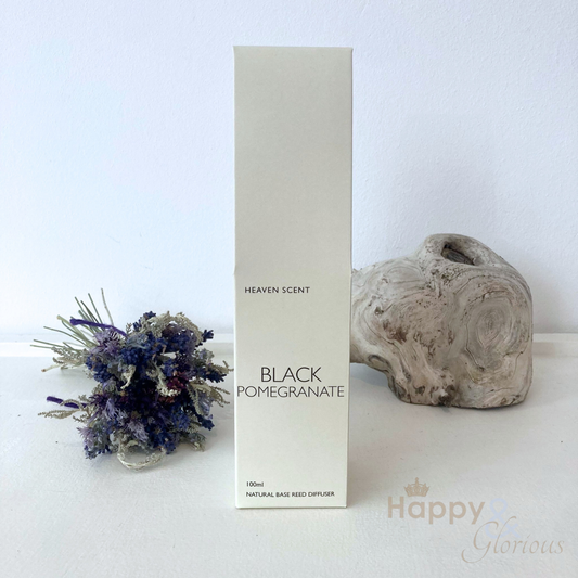 Black pomegranate reed diffuser in amber glass bottle