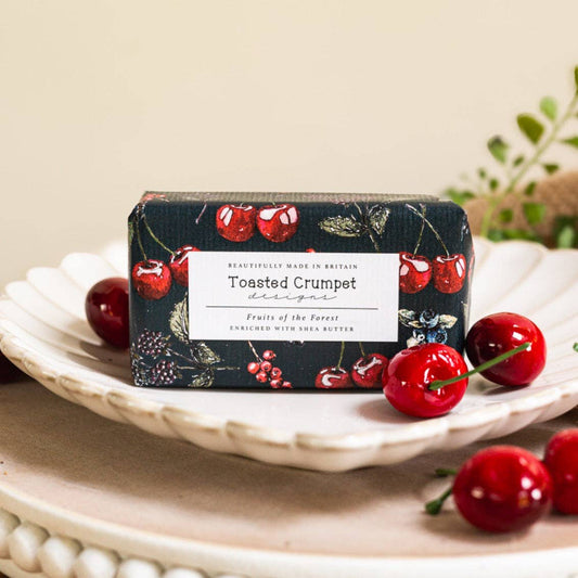 Bar of soap with cherry design on a white plate