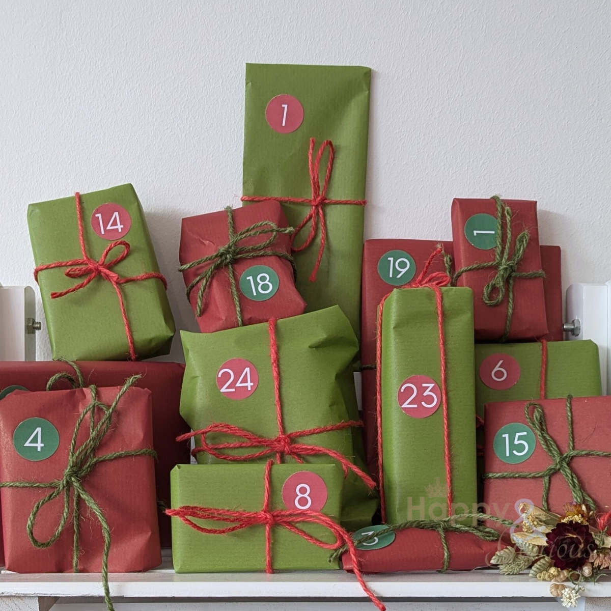 Red and green gift boxes with numbers on a white surface