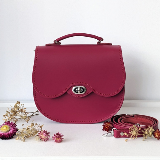 Magenta twist lock leather saddle bag