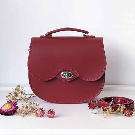 Red twist lock leather saddle bag