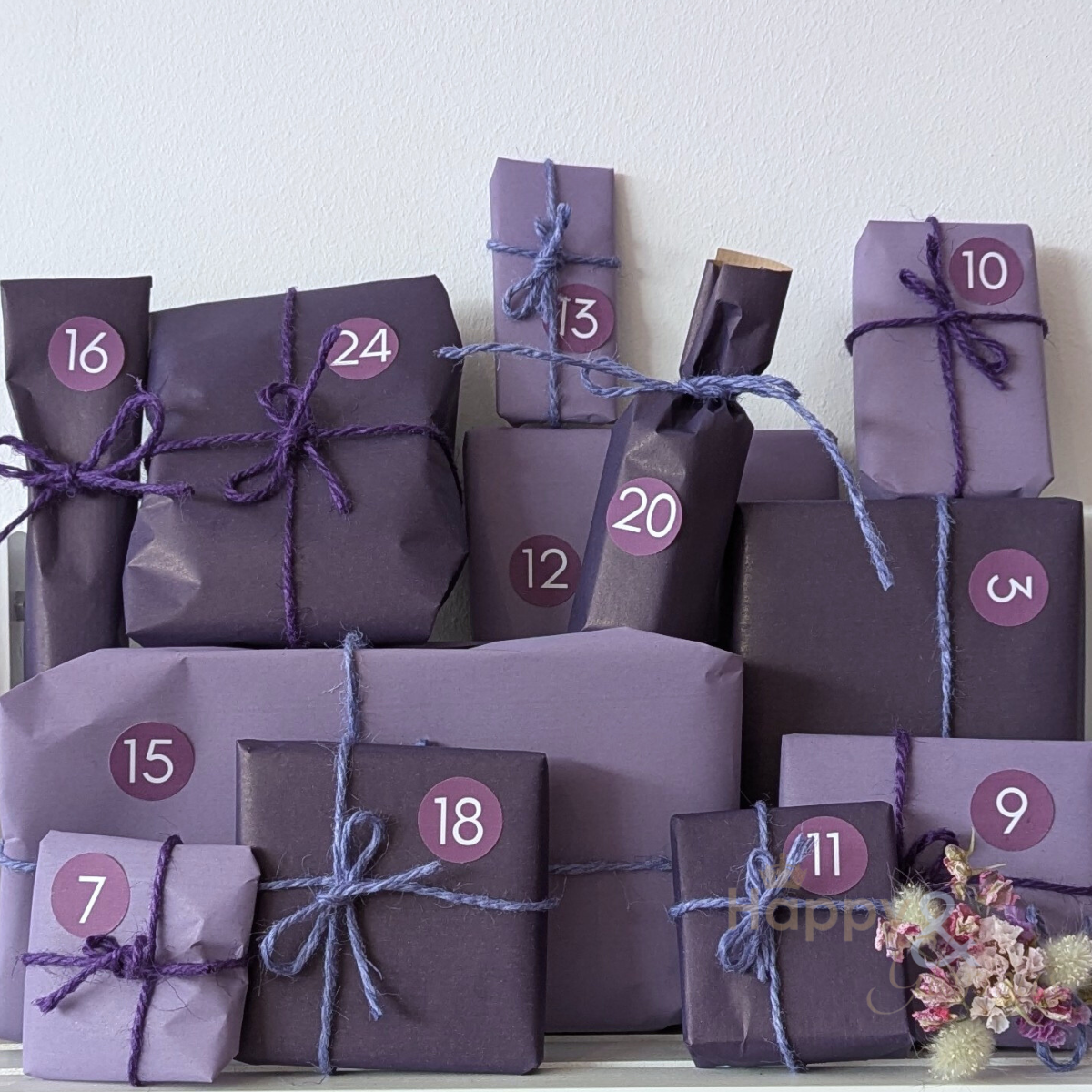 Purple gift boxes with numbers tied together on a white background