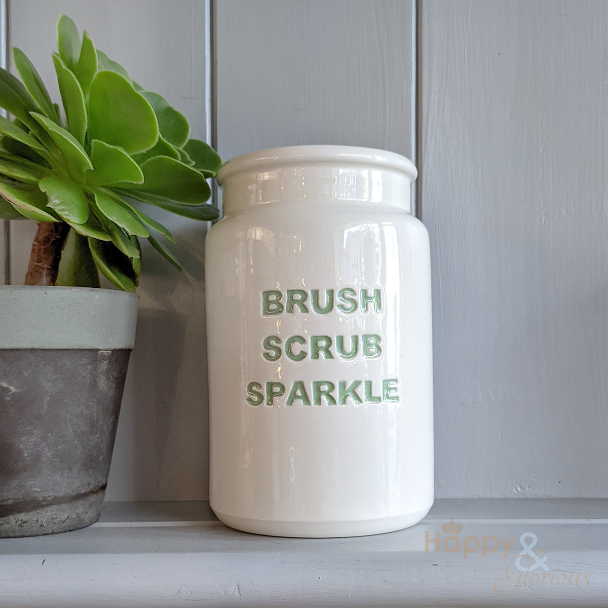 Green ceramic 'brush, scrub, sparkle' utensil pot