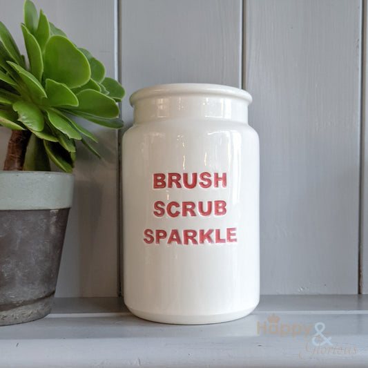 Red ceramic 'brush, scrub, sparkle' utensil pot